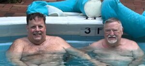 two senior people enjoying in pool